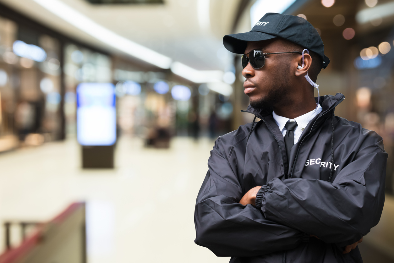 Security Guard Officer Standing In Shopping Mall